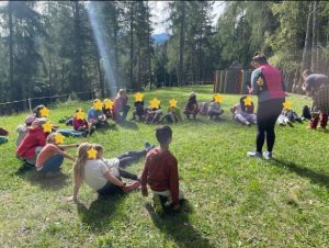 bambini in cerchio seduti che ascoltano